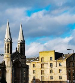 Low angle view of buildings in city against sky