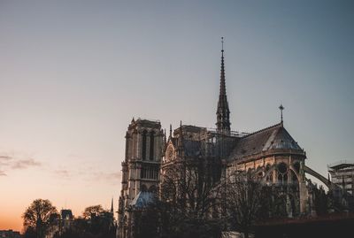 Low angle view of traditional building against sky during sunset