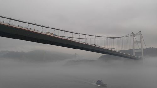 Low angle view of bridge on a foggy day