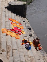 High angle view of people sitting on shore