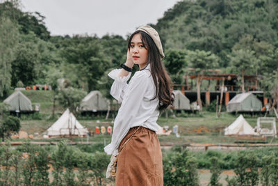 Full length of young woman standing on field