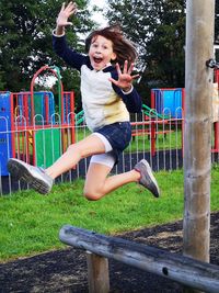 Portrait of smiling girl standing against plants