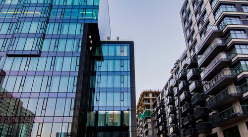 Low angle view of modern buildings against clear sky