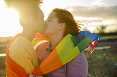 Woman with eyes closed kissing girlfriend