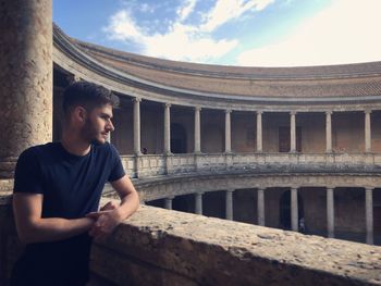 Handsome young man standing in balcony at palace of charles v