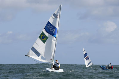 People on sea against sky