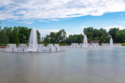 Gazebo by lake against sky