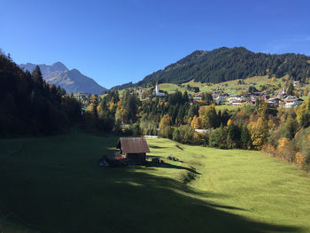 Scenic view of trees and buildings against clear sky