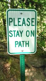 Close-up of warning sign on road