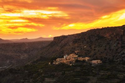Scenic view of mountains against orange sky