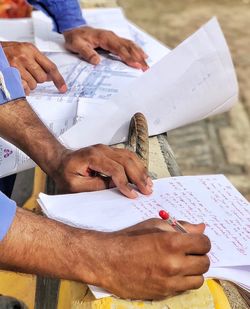 Low section of people working on table