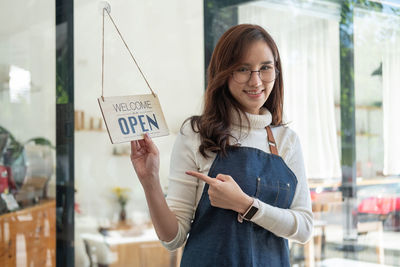 Portrait of young woman using digital tablet