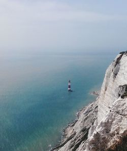 Scenic view of sea and mountains against sky