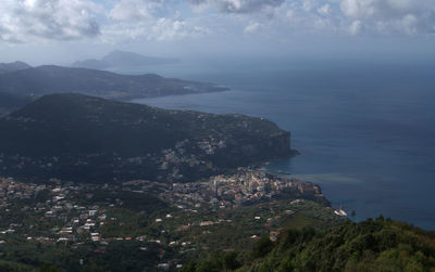 High angle view of sea and mountains against sky