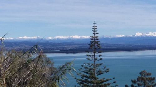 Calm lake with mountains in background