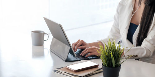 Low angle view of woman working on table