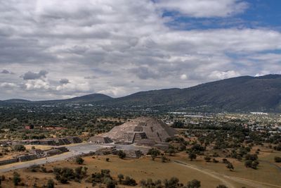 Aerial view of town against cloudy sky