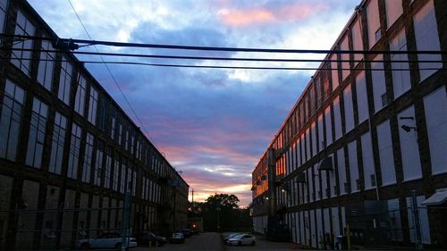 Low angle view of buildings against cloudy sky