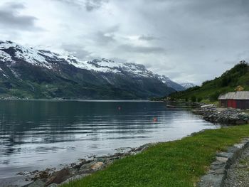 Scenic view of lake and mountains against sky