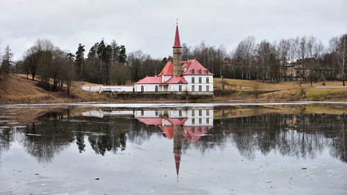Reflection of building in lake against sky