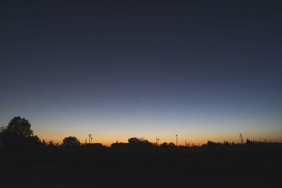 Silhouette landscape against clear sky during sunset