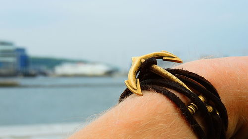 Close-up of anchor shaped bracelet on hand