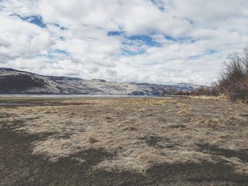 Scenic view of landscape and mountains against sky