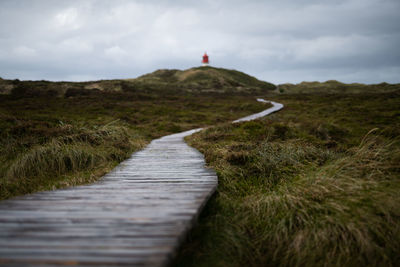 Path to lighthouse on amrum island germany after the rain on cloudy day