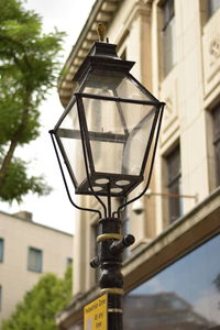 Low angle view of street light against building