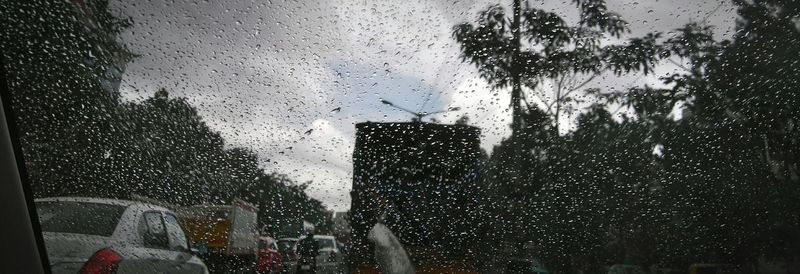 Raindrops on street seen through wet window