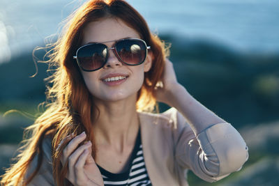 Portrait of smiling young woman wearing sunglasses