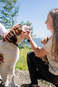 Couple travelling with dogs at the mountains, st.bernard dog and yourkshire terrier