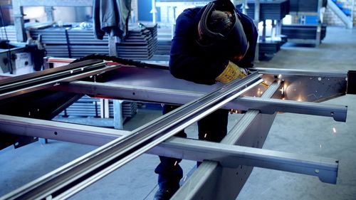Rear view of woman working in factory