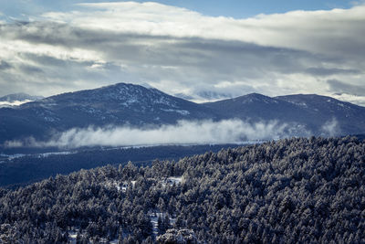 Scenic view of mountains against sky during winter