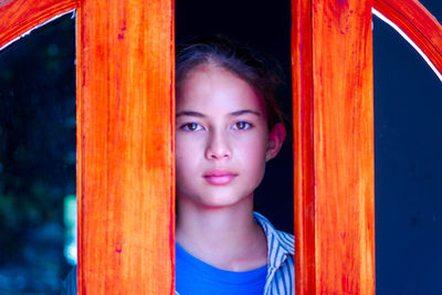 A beautiful girl stands by the door of the reception room. an inviting face and eyes