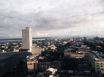 Cityscape against cloudy sky