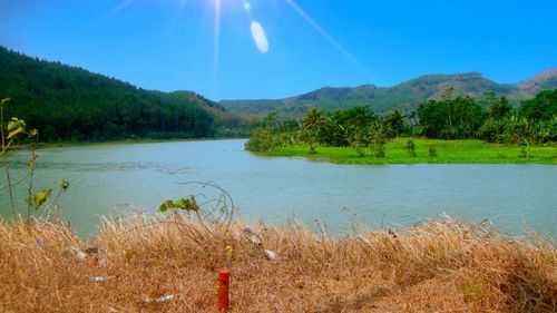 Scenic view of lake and mountains against sky