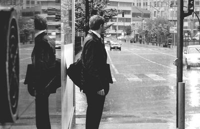 Rear view of men walking on road