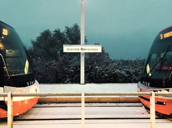 Close-up of information sign against sky