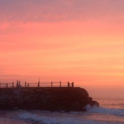 Scenic view of sea against orange sky