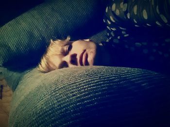 Close-up of cat sleeping on sofa