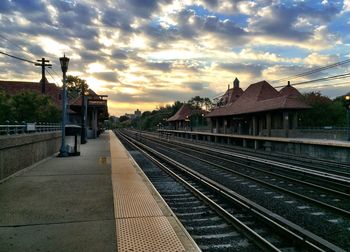 Railroad track against cloudy sky