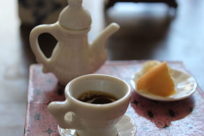 Close-up of black coffee with food on table