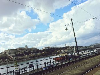 View of bridge over canal against cloudy sky