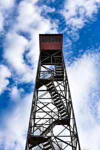 Low angle view of tower against blue sky