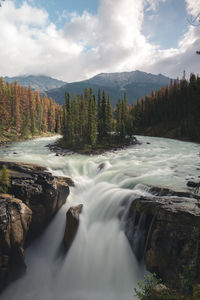 Scenic view of waterfall against sky