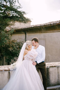 Couple holding camera in garden