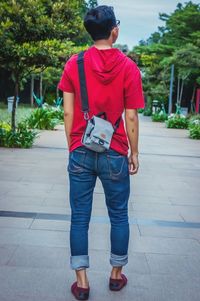 Rear view of man standing on footpath