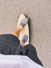 Low section of man standing on skateboard