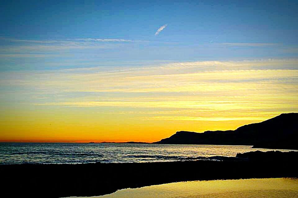 sea, sunset, water, scenics, tranquil scene, beauty in nature, tranquility, horizon over water, sky, beach, silhouette, idyllic, nature, orange color, shore, mountain, coastline, cloud, cloud - sky, non-urban scene